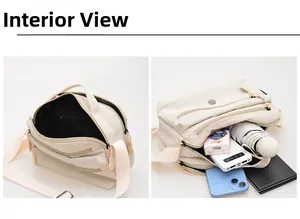 Detail view of large capacity off-white canvas bag interior with dual zippers