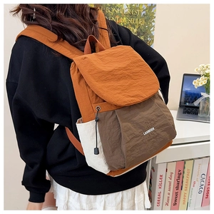 Close-up of the stylish two-tone nylon backpack with metal eyelets and branded flap detail