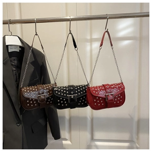 Detailed view of three rivet handbags in coffee, black and red colors with chain straps