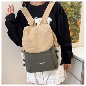 Detail of a large nylon travel backpack with khaki and army green color block design