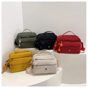 Multiple colors of lightweight nylon crossbody bags with multi-layer zipper pockets