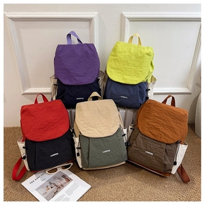 Close-up of lightweight nylon travel backpacks in multiple vibrant colors and textures