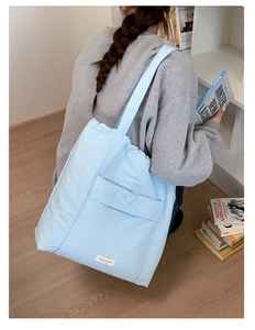 Detailed back view of a sky blue large tote bag featuring a drawstring closure design