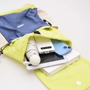 Detail showing spacious interior storage of a color-block nylon backpack with gadgets