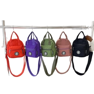 Waterproof nylon crossbody bag collection in five vibrant colors with adjustable strap