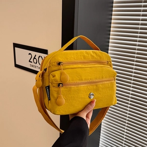 Bright yellow multi-layer nylon crossbody bag with shoulder strap for women