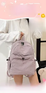 Detailed macro view of light purple nylon backpack featuring drawstrings and black zippers