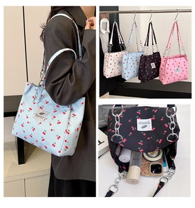 Detailed views of cherry print canvas tote bags in four colors with chain straps