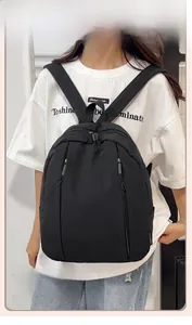 Detail view of water-resistant black nylon backpack with vertical double-zipper front pockets