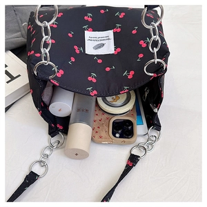 Detail of cherry print tote bag showing spacious interior with metal chain handle