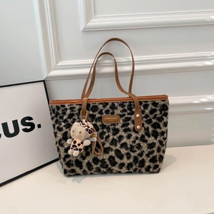 Chic leopard print plush tote bag with brown leather trim and a cute cat charm detail