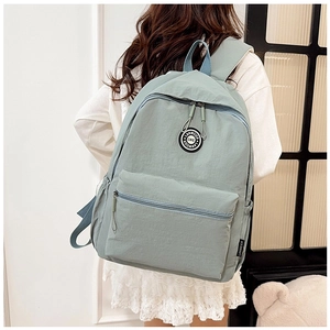 Detailed view of mint green waterproof nylon backpack with branded LANWEIER circular patch