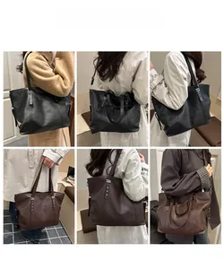 Mehrere Ansichten einer großen Nieten-Tote-Bag als Schulter- und Handtasche