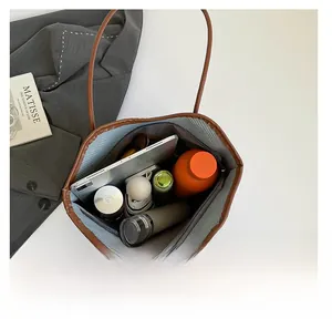 Macro detail of spacious brown tote bag interior showing ample storage for daily essentials