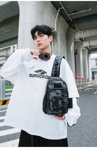 Tactical camouflage chest bag with D-ring and zipper pockets shown in street style wear