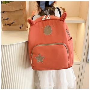 Detail of coral pink kids backpack with 3D animal ears and cute bear embroidery on top