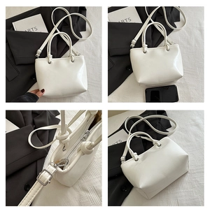 Detailed views of white PU leather bucket bag with dual handles and adjustable shoulder strap
