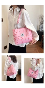 Detail shots of pink canvas tote bag with cherry print and metal chain strap on model