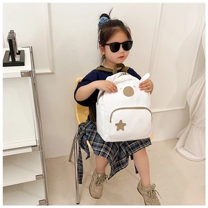 Detailed view of white children's backpack with cute rabbit ears and star patch