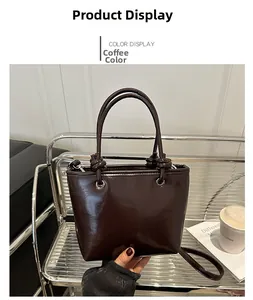 Brown bucket bag detail showing glossy leather texture and stylish knot strap detail