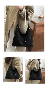 Detail of black hobo bag with leopard print, gold studs and spacious interior