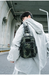 Detail of camoufalge tactical chest bag with adjustable strap and multiple compartments
