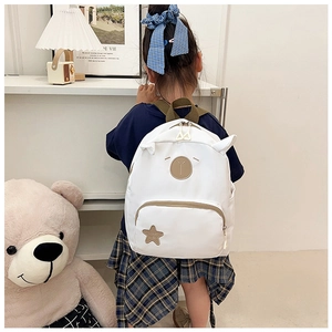 Detailed back view of white cartoon animal backpack with 3D ears on a child model