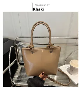 Detailed close-up of khaki PU leather bucket bag with unique knot handle design
