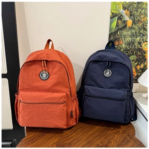 Detailed view of durable nylon backpack with side pockets and front zipper compartment