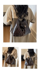 Close-up of vintage dark brown faux leather backpack featuring a drawstring and metal buckle