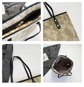 Close-up of quilted tote bag featuring cloud dye pattern and black leather handles