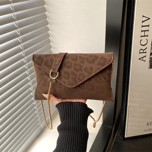 Fashionable dark brown leopard print envelope bag with a thin gold chain strap