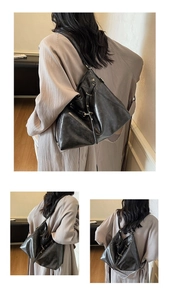 Detail of black soft leather backpack showing smooth texture and versatile straps