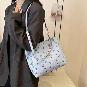 Light blue cherry print tote bag with silver chain strap for casual spring style