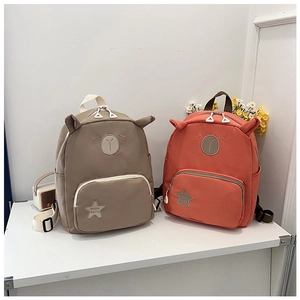 Detail view of water-resistant kids backpacks with animal ear designs and star patches