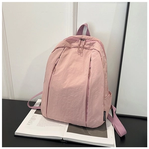 Pink wrinkled nylon backpack featuring a double zipper design and multiple side pockets