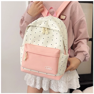 Detail of star backpack with polka dot print and pink contrast stitching for teenagers