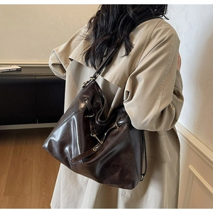 Detail of vintage brown oil wax leather backpack with antique bronze metal buckles