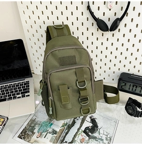 Tactical olive green sling bag with multiple pockets and velcro patch area on a desk