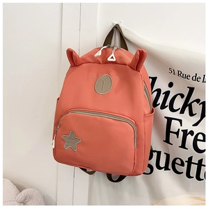 Detail of pink nylon school bag featuring cute 3D ears and durable double zippers