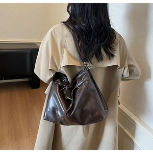 Deep brown retro faux leather hobo tote bag shown on model for back-view styling
