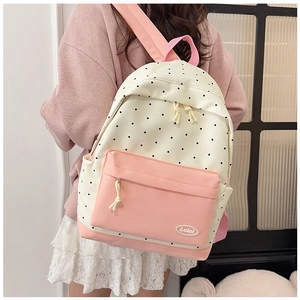 Detailed close-up of a sweet polka dot backpack featuring pink straps and Lolo logo badge