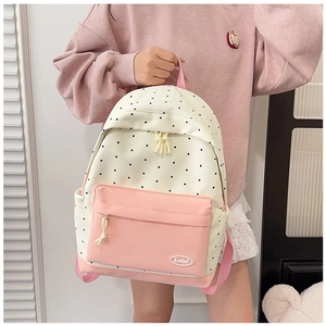 Close-up of beige polka dot canvas backpack with pink paneling and Lolol logo