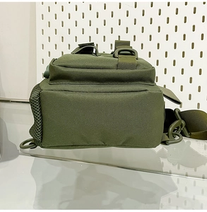 Detail of olive green tactical shoulder bag with side mesh pocket and durable nylon texture