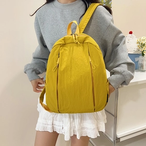 Minimalist solid yellow large capacity backpack with waterproof fabric for daily commute
