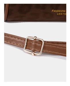 Detailed view of brown leather strap with gold buckle and Fashion Leather logo