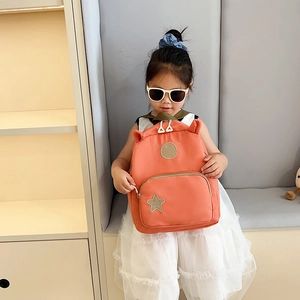 Cute pink cartoon bear backpack for toddlers featuring 3D ears and star patch design