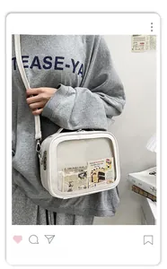 Detail of a beige ita bag with clear window showing retro newspaper and cake card inserts