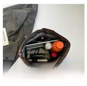 Spacious interior of brown tote bag showing zipper pocket and daily essentials storage