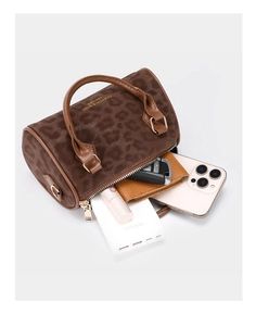 Detail showing high capacity of leopard print boston bag with phone, wallet and lipstick